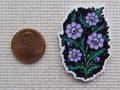 Second view of Spooky purple flowers with skulls as their center.