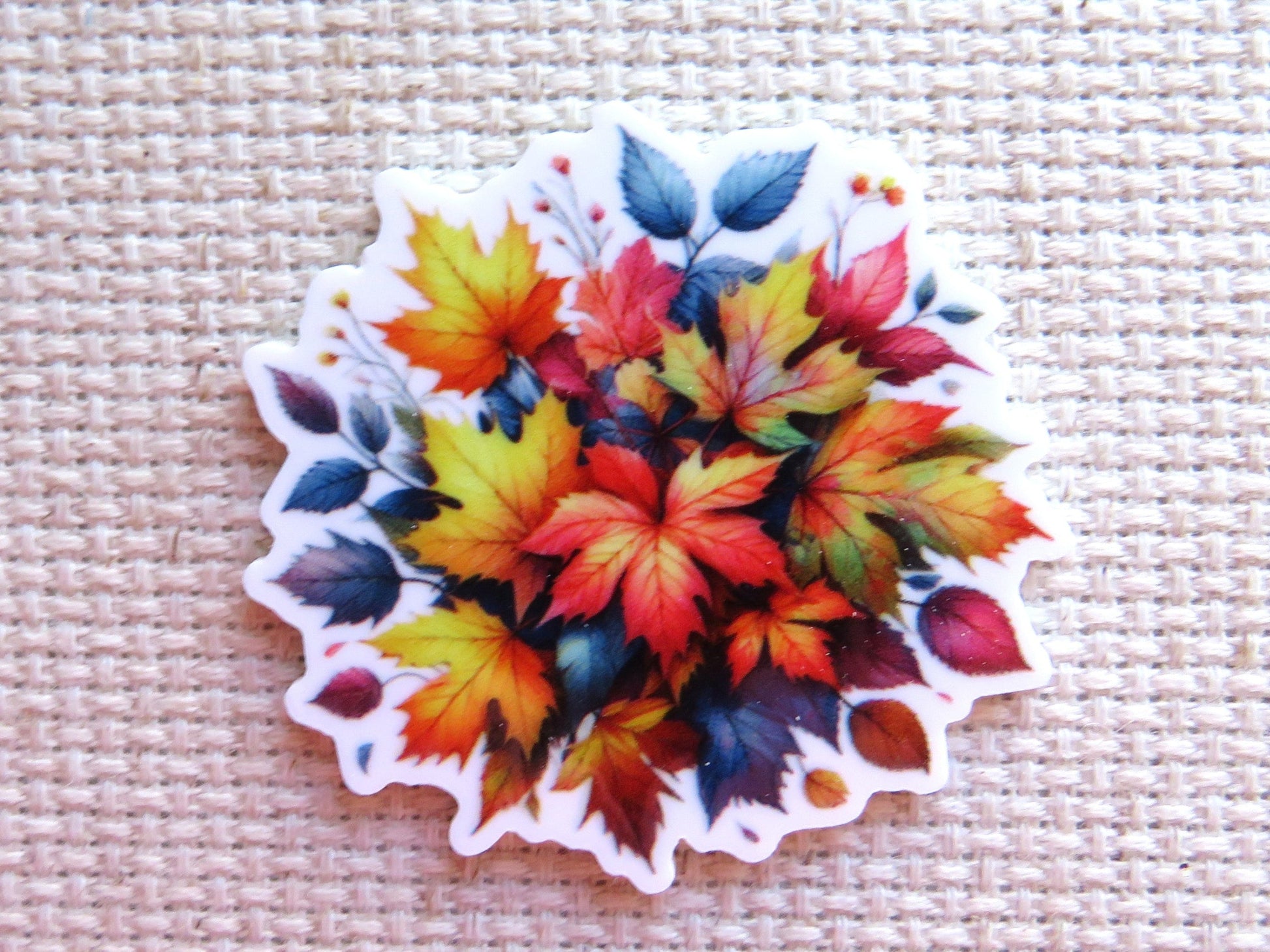 First view of A Burst of Fall Colors Needle Minder, multicolored fall leaves in a bunch.