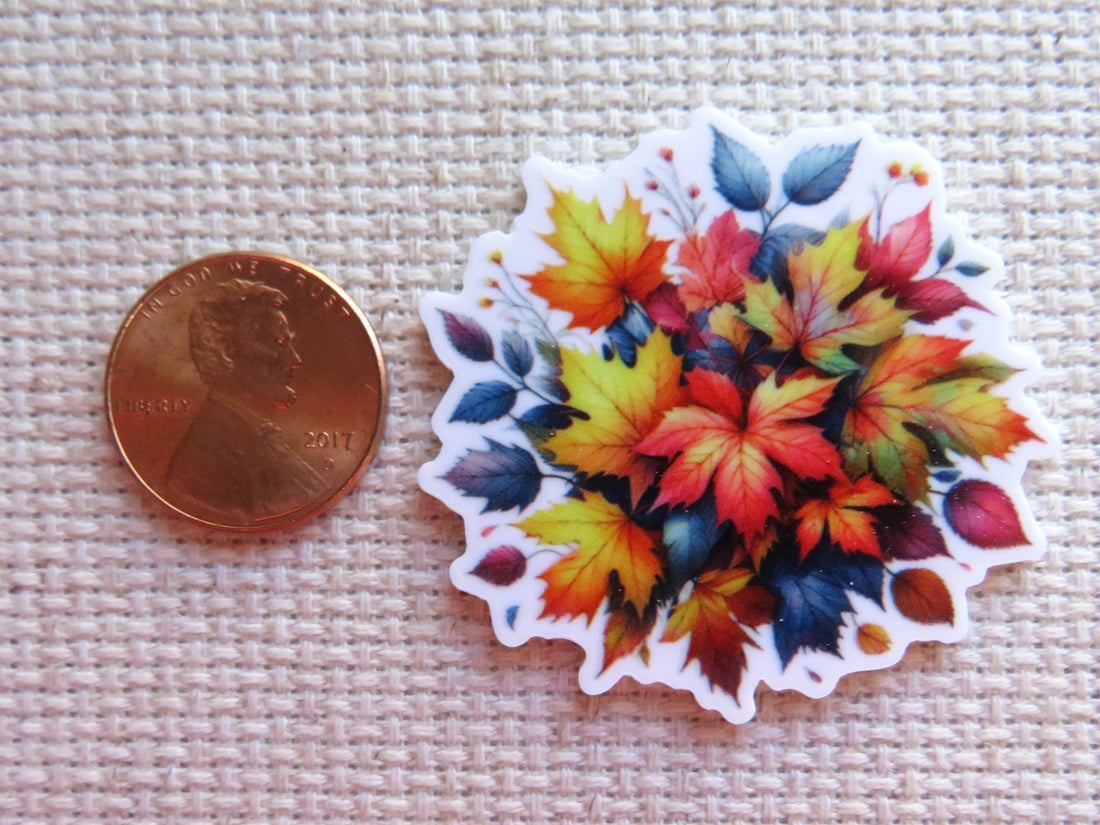 First view of A Burst of Fall Colors Needle Minder, multicolored fall leaves in a bunch.