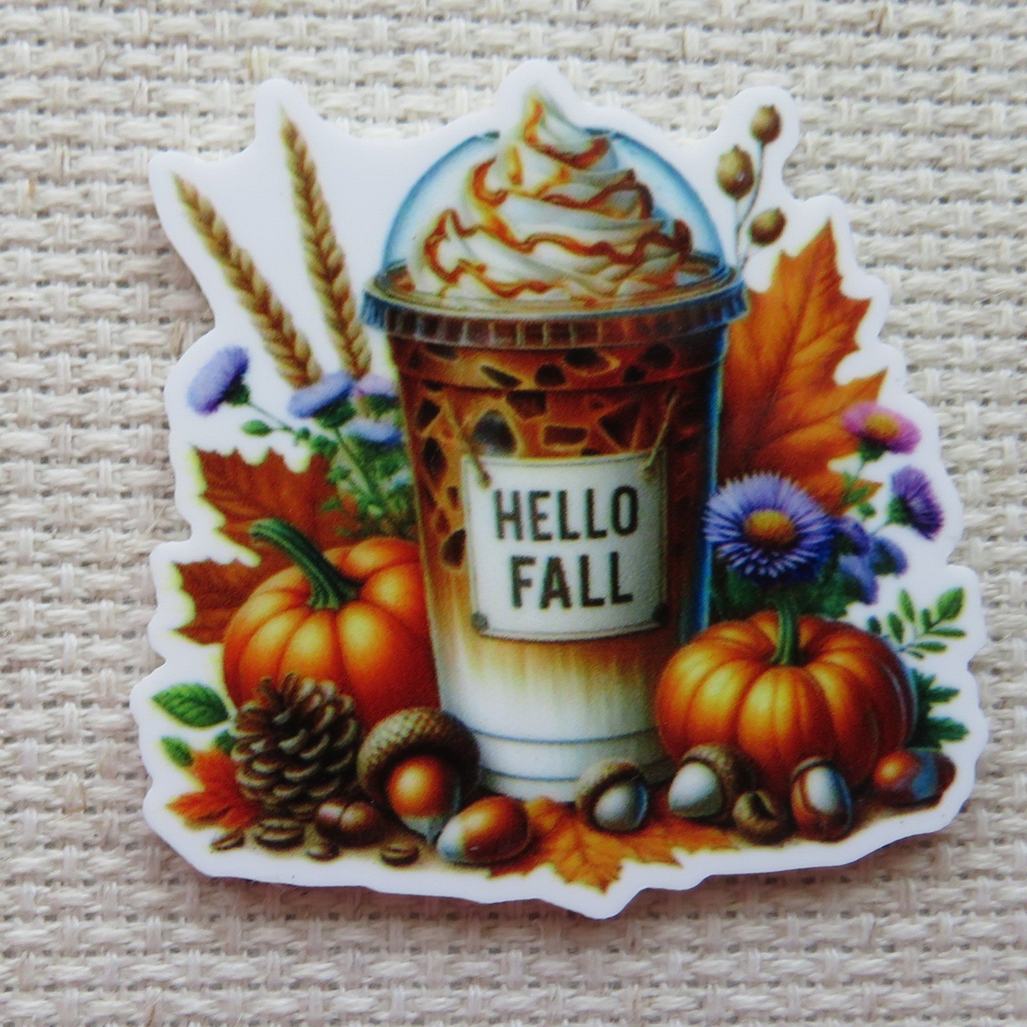 First view of Yummy looking pumpkin flavored drink with pumpkins, acorns, a pinecone, fall leaves and flowers surrounding it minder.