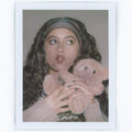 Polaroid of model wearing Infinity Headband in Mousse while holding teddy bear.