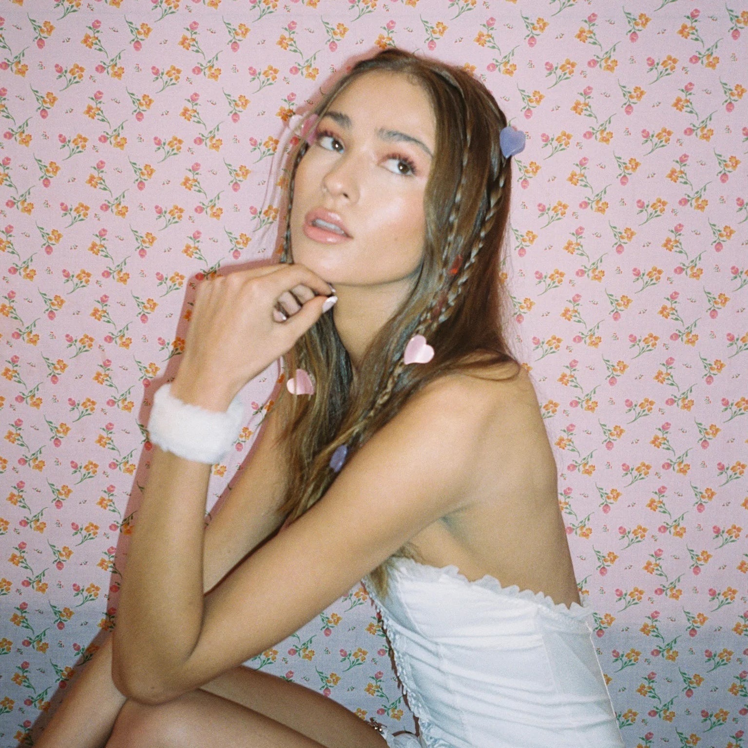 model with Baby Heart Clip Set in Sweet + Tart in hair and hand on chin