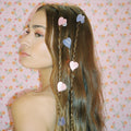 model looking away with Baby Heart Clip Set in Sweet + Tart in hair